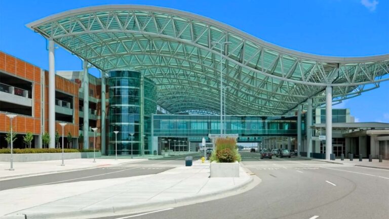 gerald r ford pickup at GRR arrivals pickup curb — grand rapids airport rides meet-up under the glass canopy